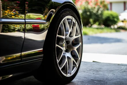 a picture of a black car's shiny tire