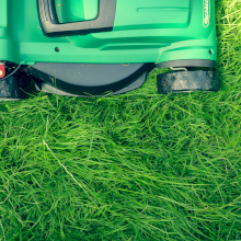 Top down picture of a lawnmower over grass